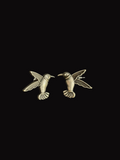 Pair of silver hummingbird earrings on a black background
